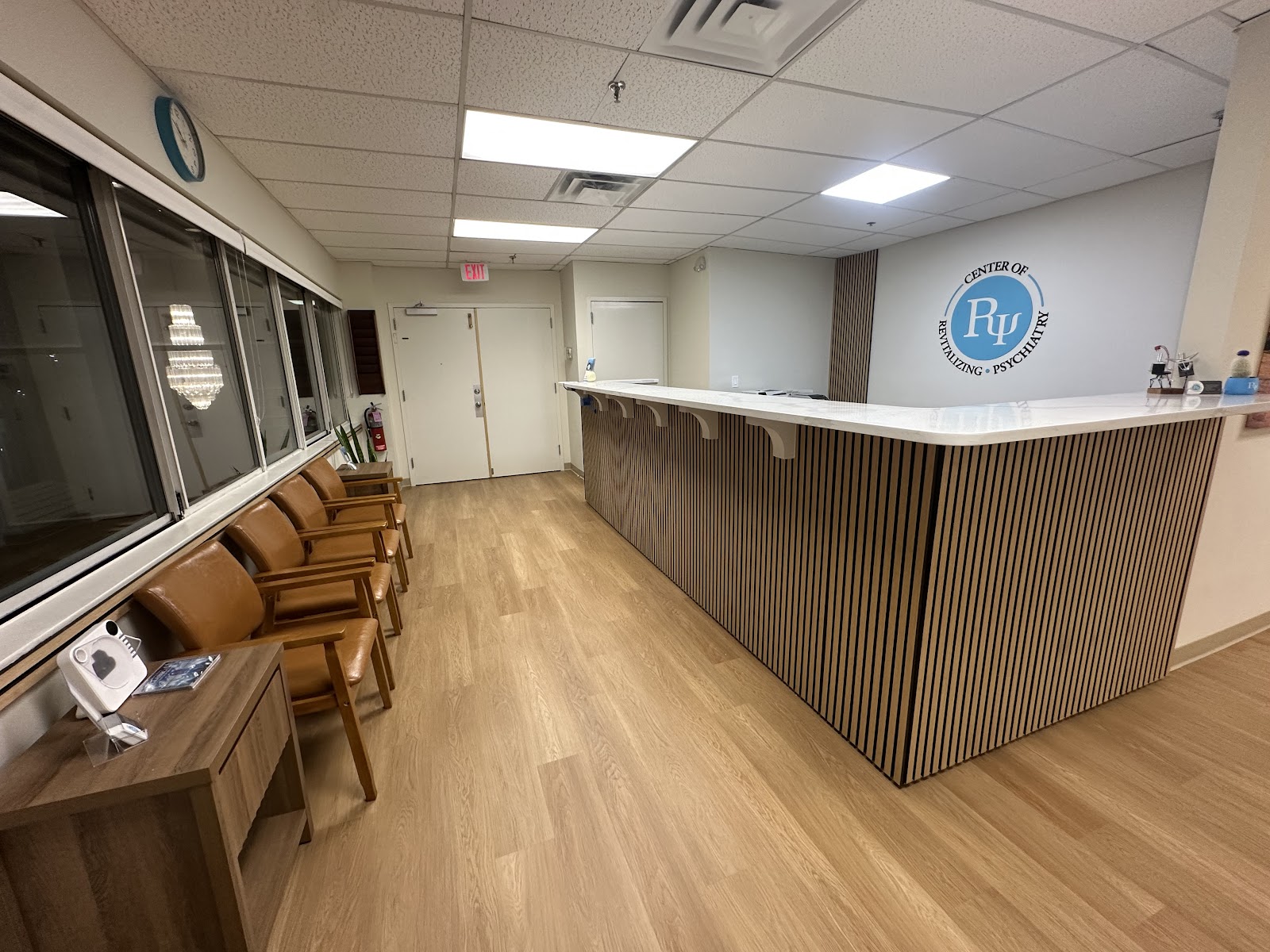 Reception desk beside the logo wall
